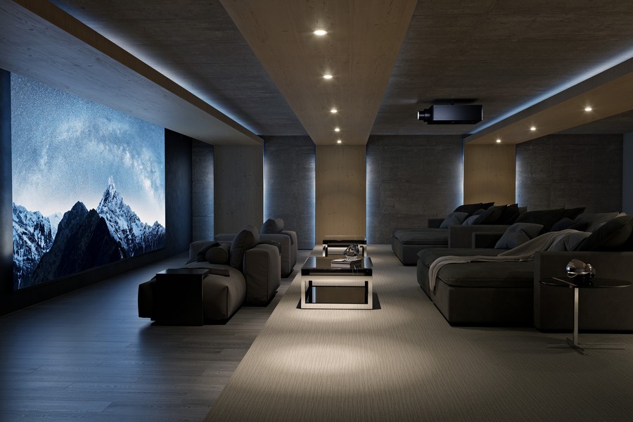 a home theater with a projector, comfortable seating, and dimmed lights