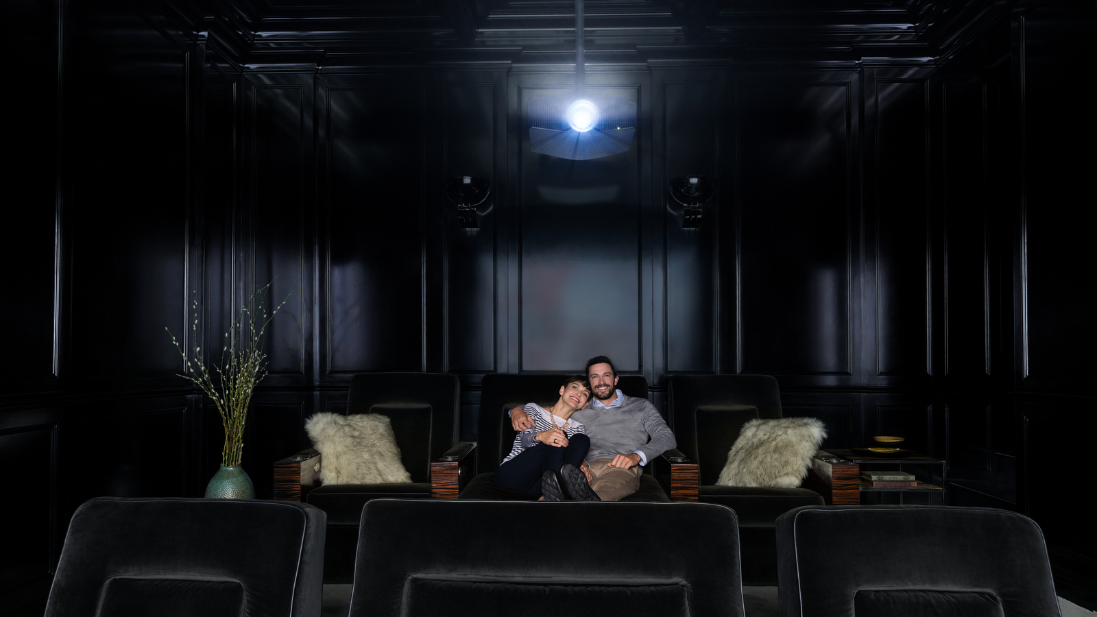 couple watching movie on fancy home theater