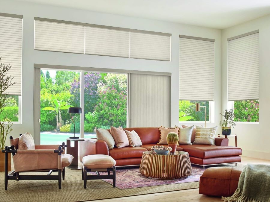 A living room with motorized shades partially lowered.